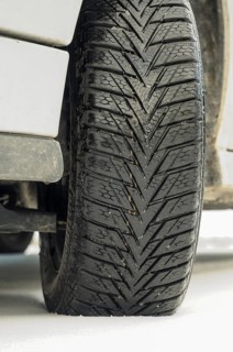 Winter tyre of a car on a snow-covered road