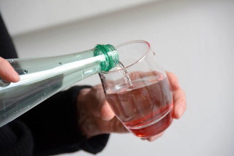Water being poured from a bottle into a glass