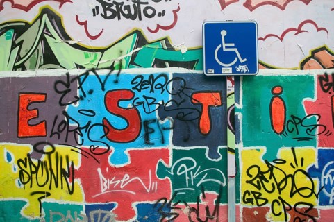 Sign Parking for disabled and wall covered with graffiti
