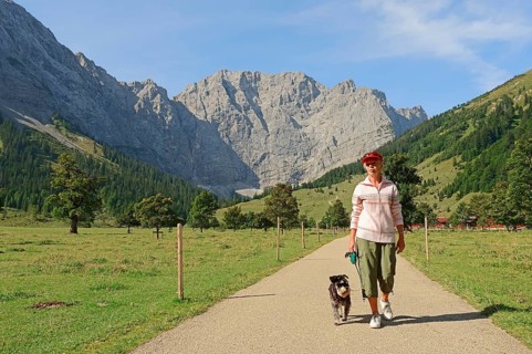 Woman hiking with a Miniature Schnauzer