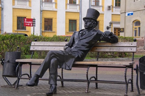 Bronze sculpture of a man with a top hat
