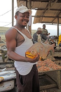 Fisherman hoding a big fish in the fishing port