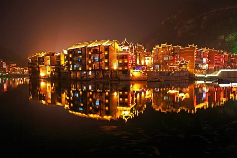 Illuminated houses on the Wuyang River at night