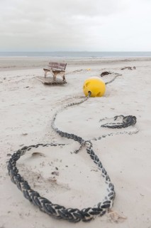 Buoy and a bench on the beach