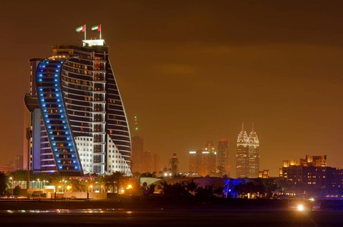 The illuminated Jumeirah Beach Hotel on Jumeirah beach at dusk