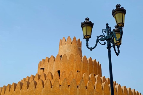 A tower of the Al Ain Palace Museum or Sheikh Zayed Palace Museum and a street lamp