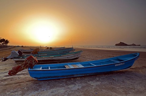 Sunset in Al Sawadi behind a couple of fishing boats