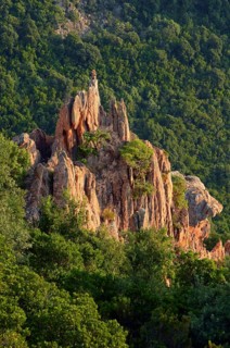 The typical bizarre red rocks of the Calanche of Pianasurrounded by green scrub. The Calanche of Piana is in the western part of the island Corsica