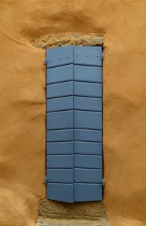 Yellow house wall and a closed blue door