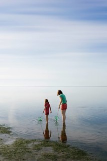 Woman and girl with dip nets standing in the Wadden Sea