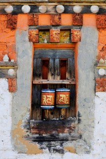Prayer wheels in the outer wall of a temple