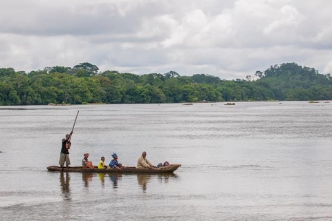 Ferryman taking passengers across the Moa River in a pirogue