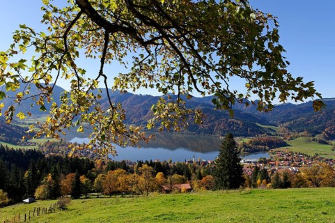 Lake Schliersee and the Parish Church of St. Sixtus as seen from Schliersberg mountain in autumn