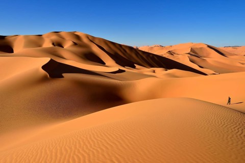 Person walking on a sand dune