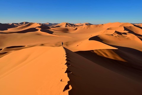 Person walking on a sand dune
