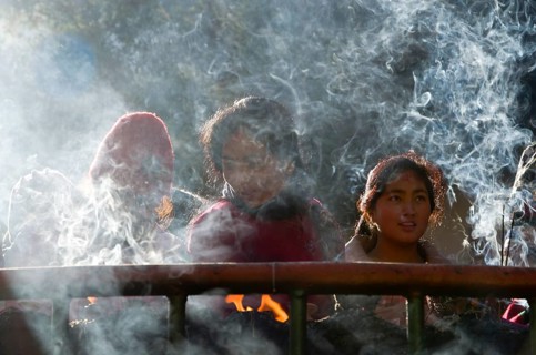 Pilgrims burning incense as an offering