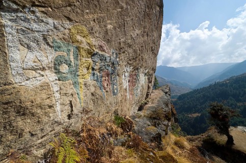 Om mani padme hum mantra painted at a big rock
