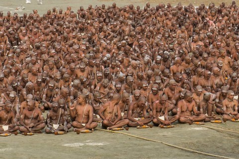Taking their first meal in the new live as part of the initiation of new sadhus at the Sangam