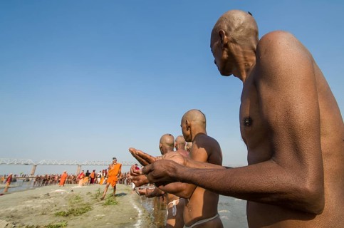 Group of men standing in the river Ganges