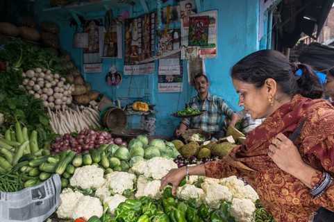 Local woman buying cauliflower at the market
