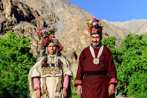 A couple of the Brokpa tribe wearing traditional dresses with flower headdresses