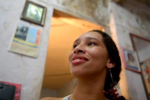 Woman in a mouldy apartment in a slum or favela