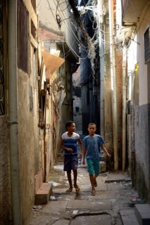 Two boys in a narrow alley in a slum or favela