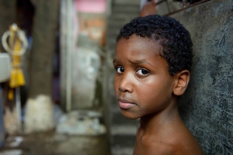 Boy with a suspicious expression in a slum or favela