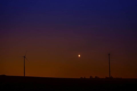 Wind turbines at full moon