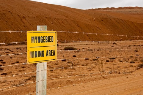 Warning sign on a barbed wire fence