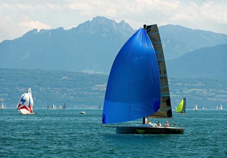 Sailboat of the Luthi 870 type with spinnaker headsail on Lake Geneva near Morges