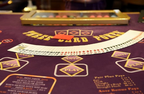 Poker table with a deck  of poker cards
