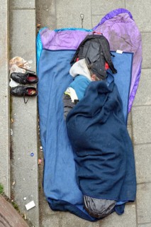 Homeless man sleeping on the ground