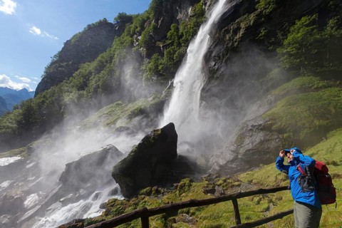 A man hiking at the waterfall of Foroglio