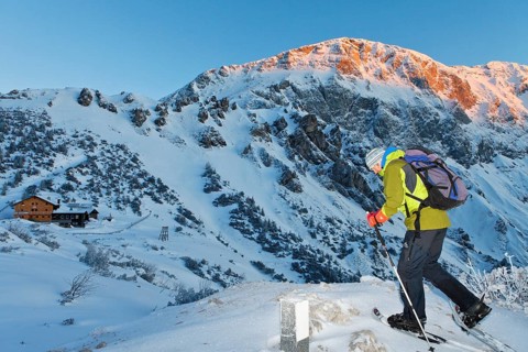 Man snowshoeing towards Carl-von-Stahl-House on Torrener Joch pass
