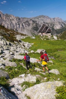 Two hikers heading towards the Rifugio Garelli mountain hut
