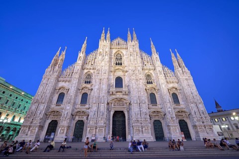 Tourists in front of the west facade of Milan Cathedral or Duomo di Santa Maria Nascente
