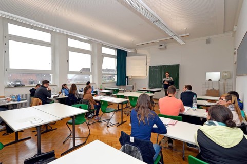 Young trainee teacher teaching a class