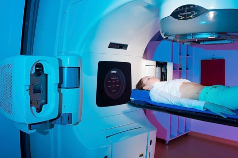 Patient lying in a linear particle accelerator for radiation treatment