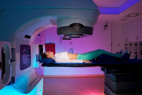 Patient lying in a linear particle accelerator for radiation treatment