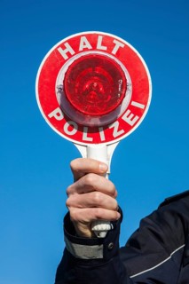 Policeman holding a police signalling disc
