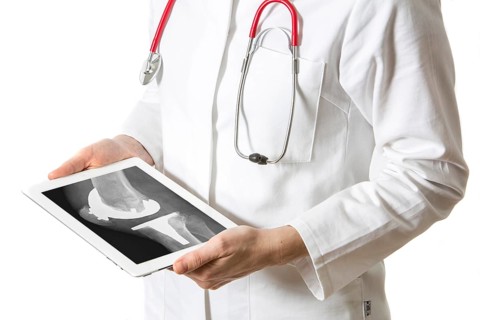 Female doctor holding a tablet computer