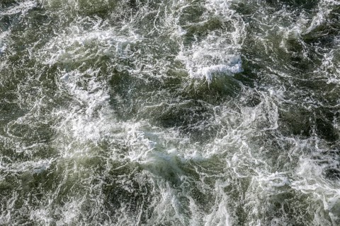 Rough waters of a river swirling after emerging from a barrage