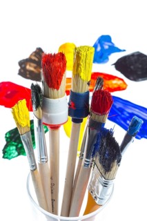 Different types of brushes with colourful acrylic paints