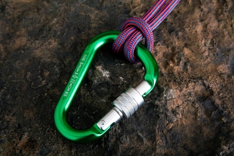 Carabiner with safety rope on a stone surface