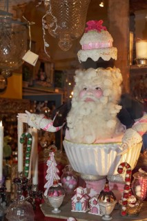 Santa Claus figure with a cake on its head