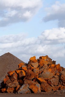 Stack of rusty ferruginous rocks waiting to be recycled