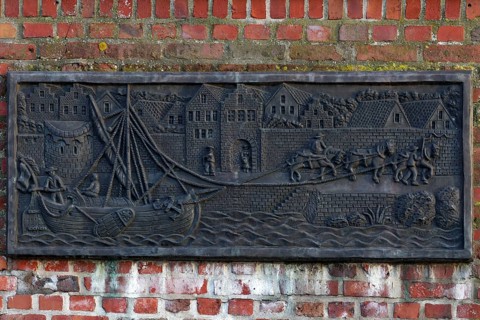 Townscape with a horse drawn boat and draught animals