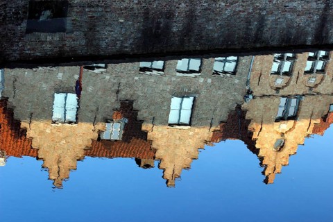 Guild houses with stepped gables being reflected in Dijver canal