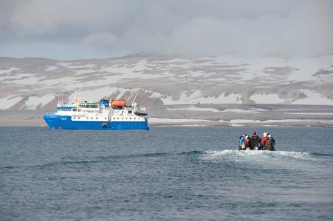 Passengers returning after being ashore in Zodiac inflatable boats to the expedition cruise ship